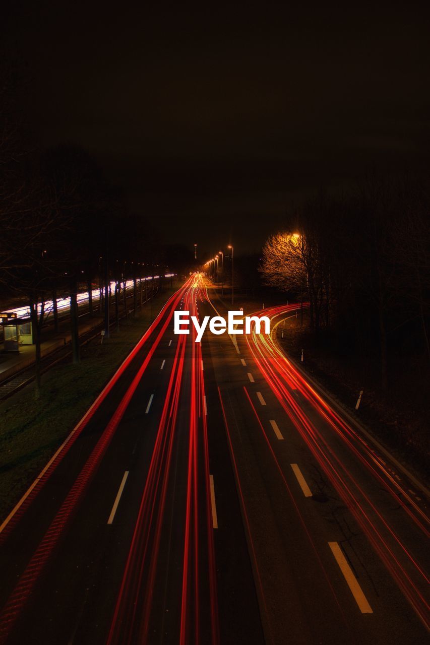 High angle view of light trails on highway at night