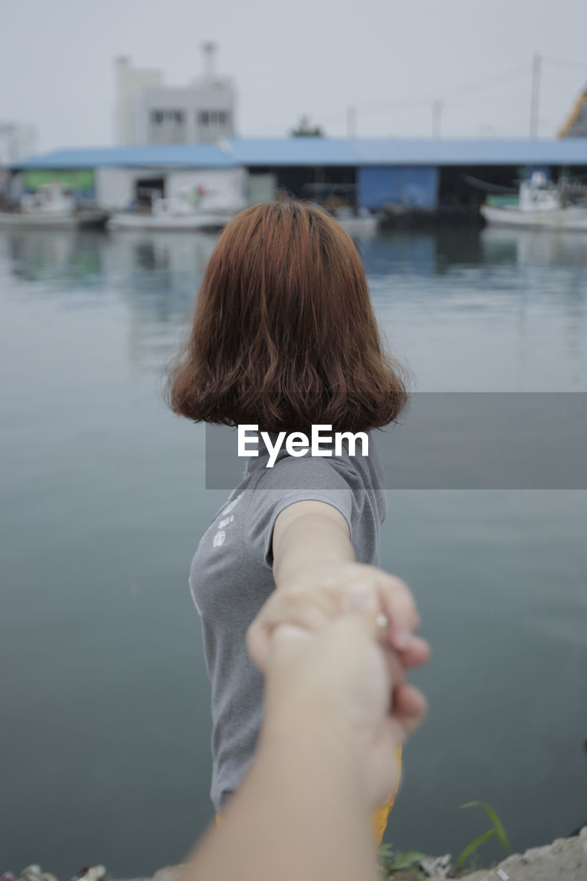 REAR VIEW OF WOMAN IN SEA