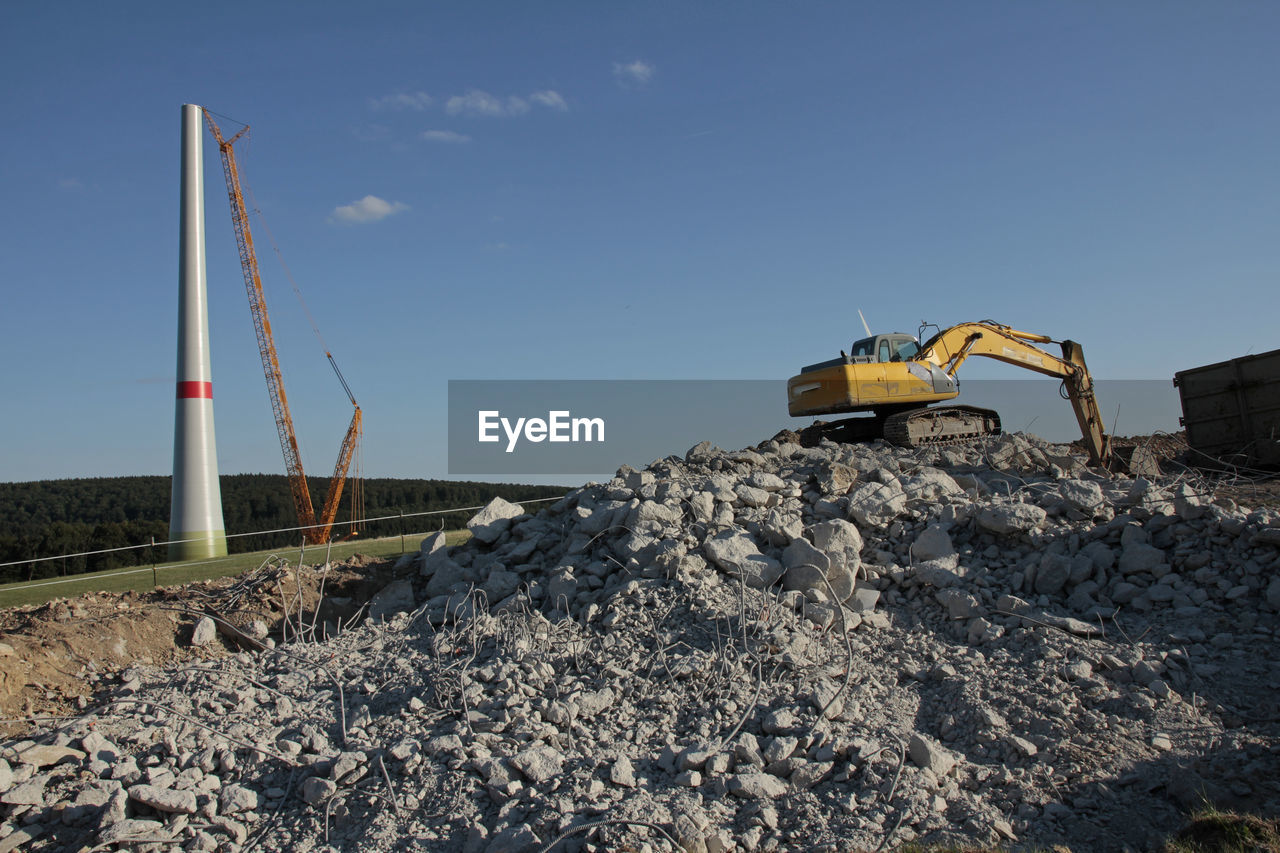 Construction site by road against sky