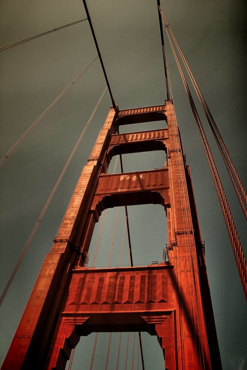 Low angle view of suspension bridge against sky