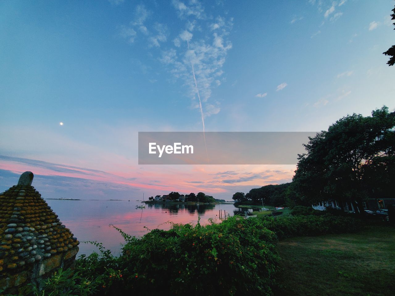 TREES BY LAKE AGAINST SKY DURING SUNSET