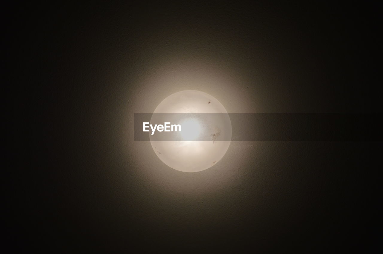LOW ANGLE VIEW OF MOON AGAINST SUN