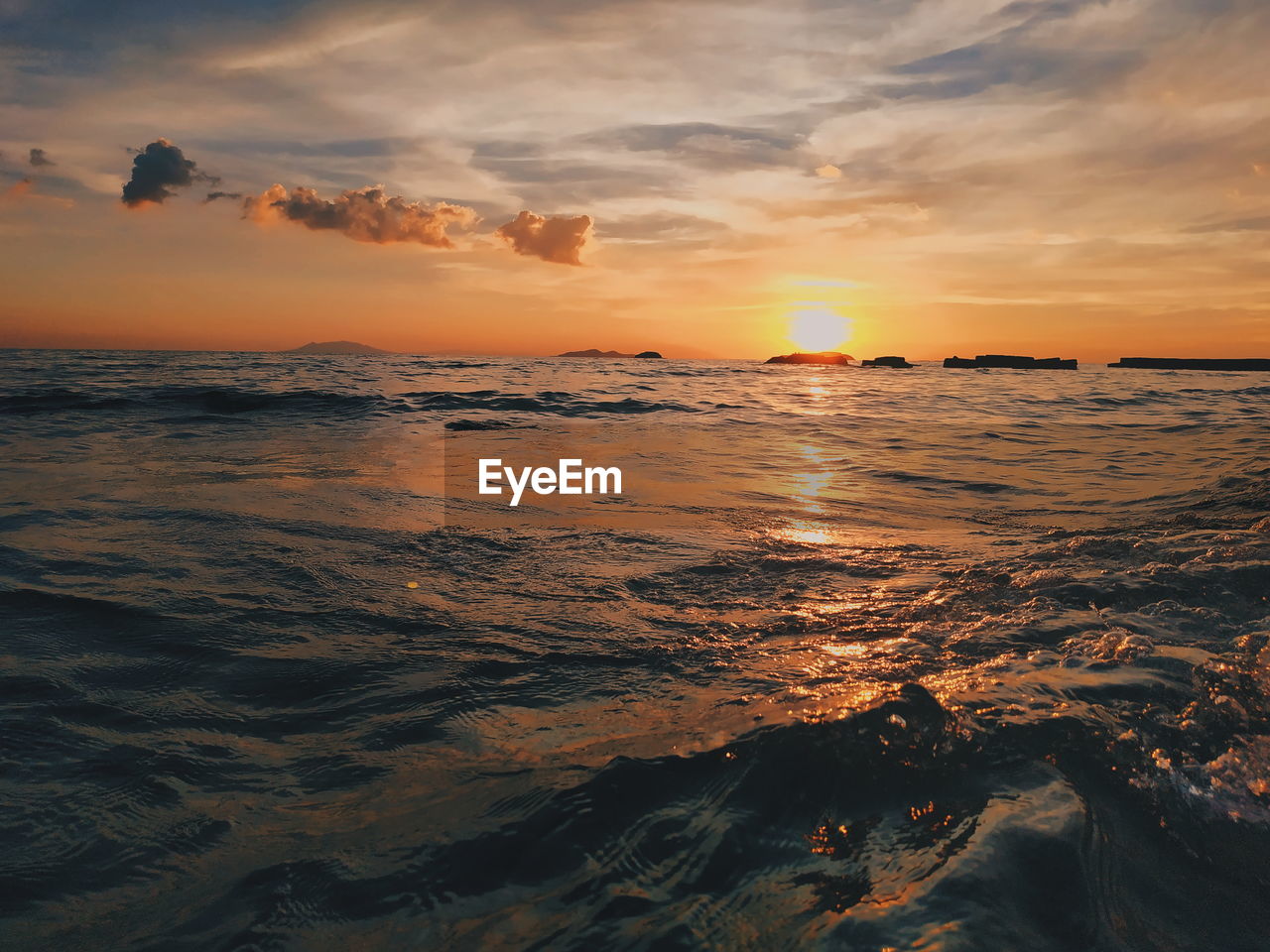 SCENIC VIEW OF BEACH AGAINST SKY DURING SUNSET