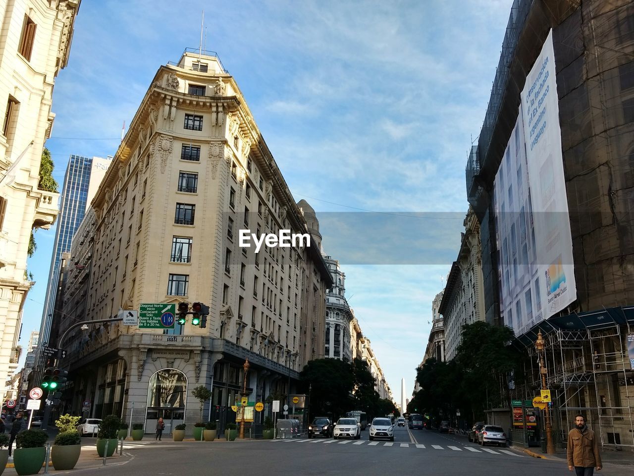 STREET AMIDST BUILDINGS AGAINST SKY