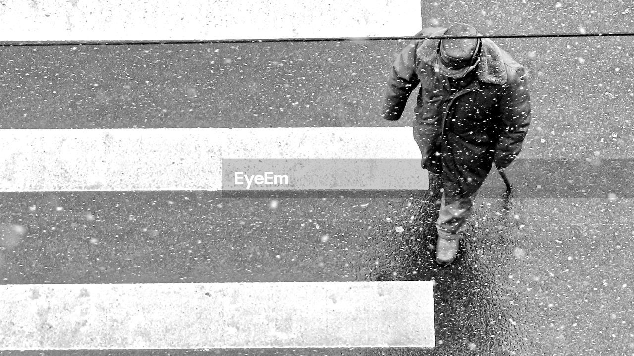 Low section of person walking on road