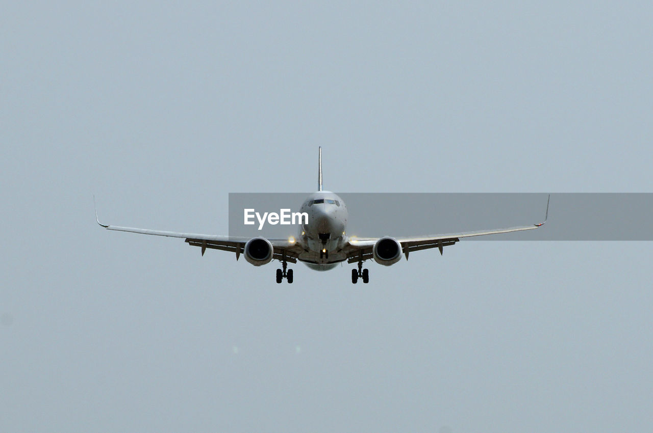 AIRPLANE FLYING AGAINST SKY