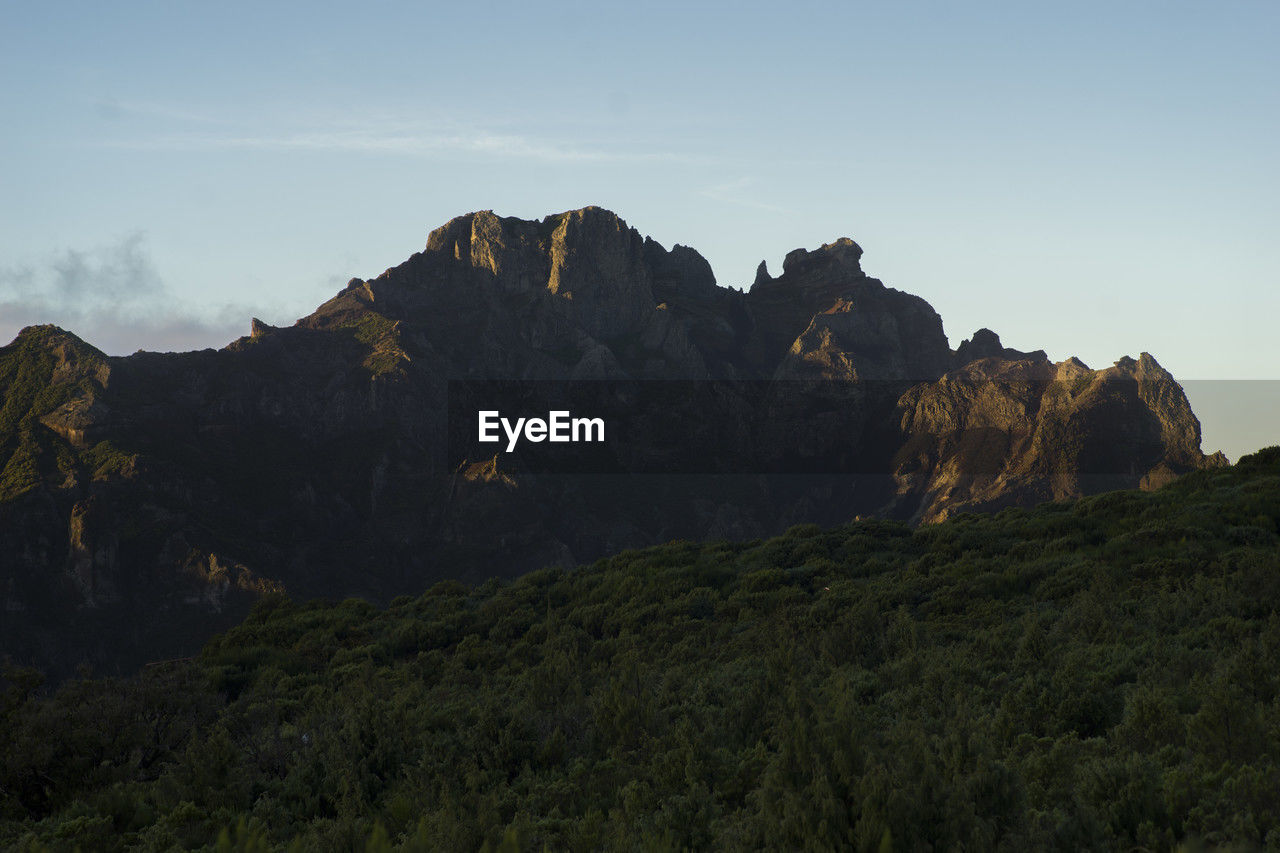 mountain, sky, landscape, environment, nature, wilderness, scenics - nature, land, beauty in nature, mountain range, rock, ridge, plant, travel destinations, travel, no people, terrain, outdoors, non-urban scene, tree, mountain peak, tranquility, valley, summit, plateau, cloud, activity, tourism, rock formation, forest, tranquil scene, animal wildlife, sunset, leisure activity