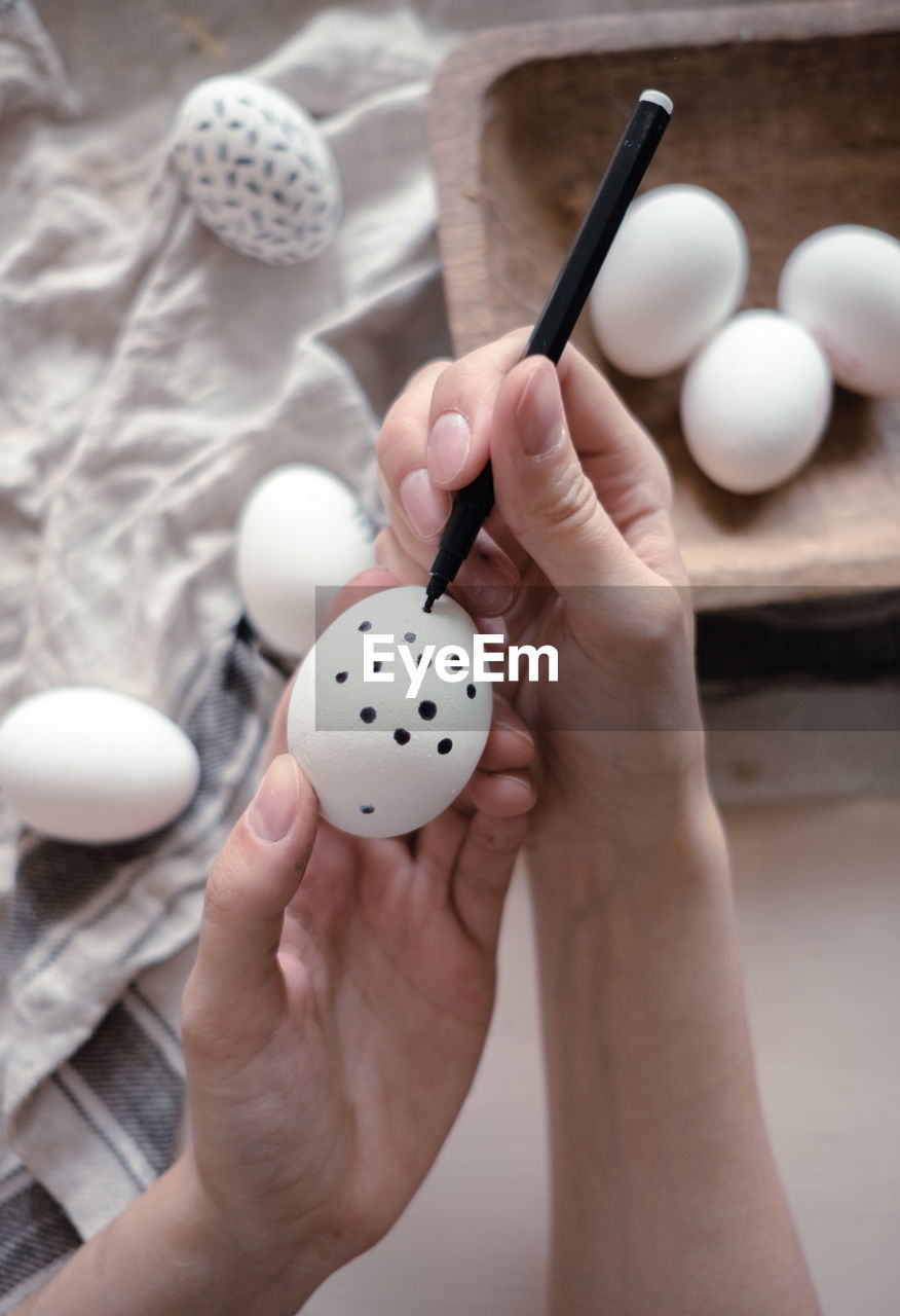 cropped image of person holding egg