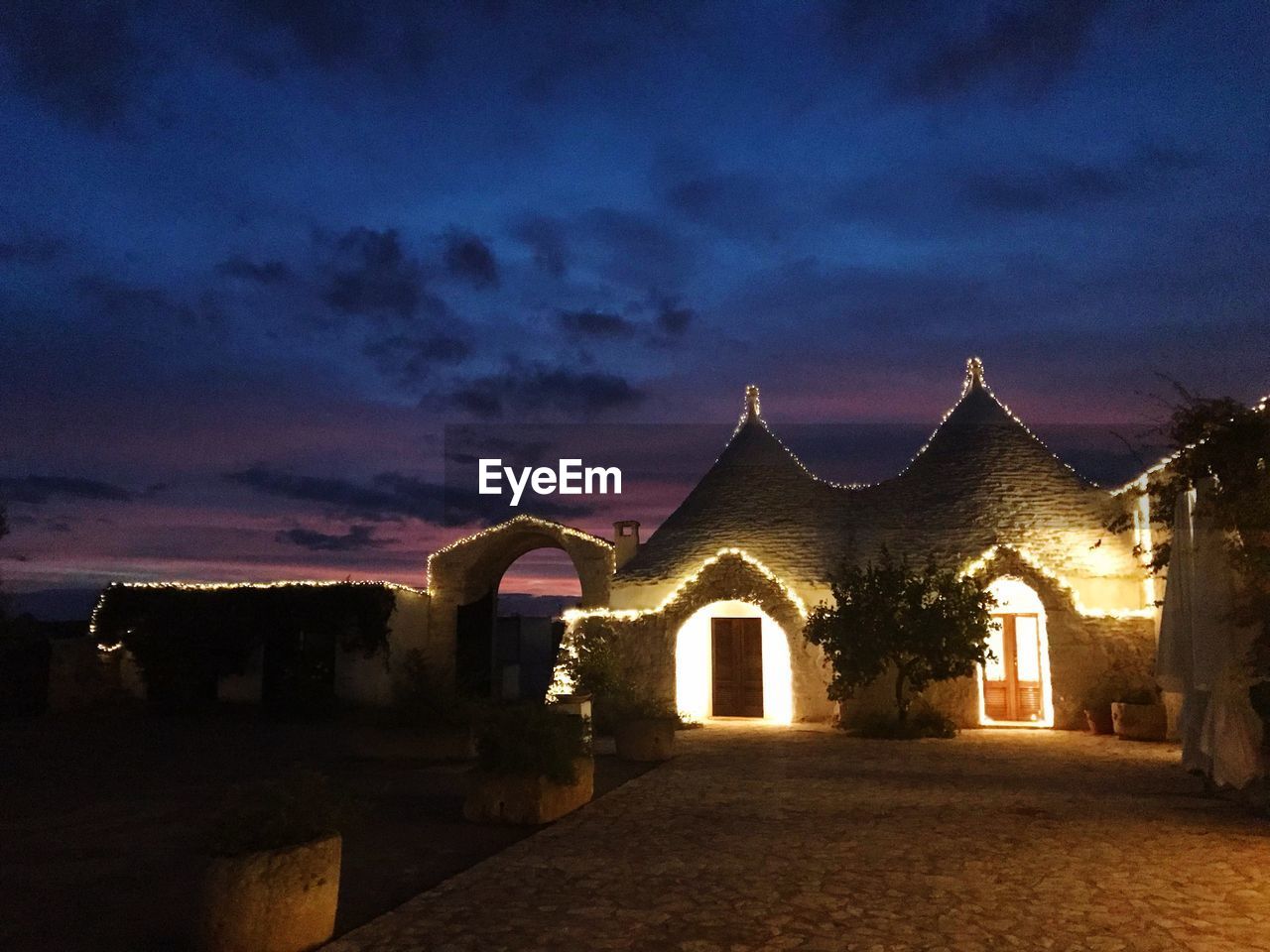 ILLUMINATED BUILDING AGAINST SKY AT DUSK
