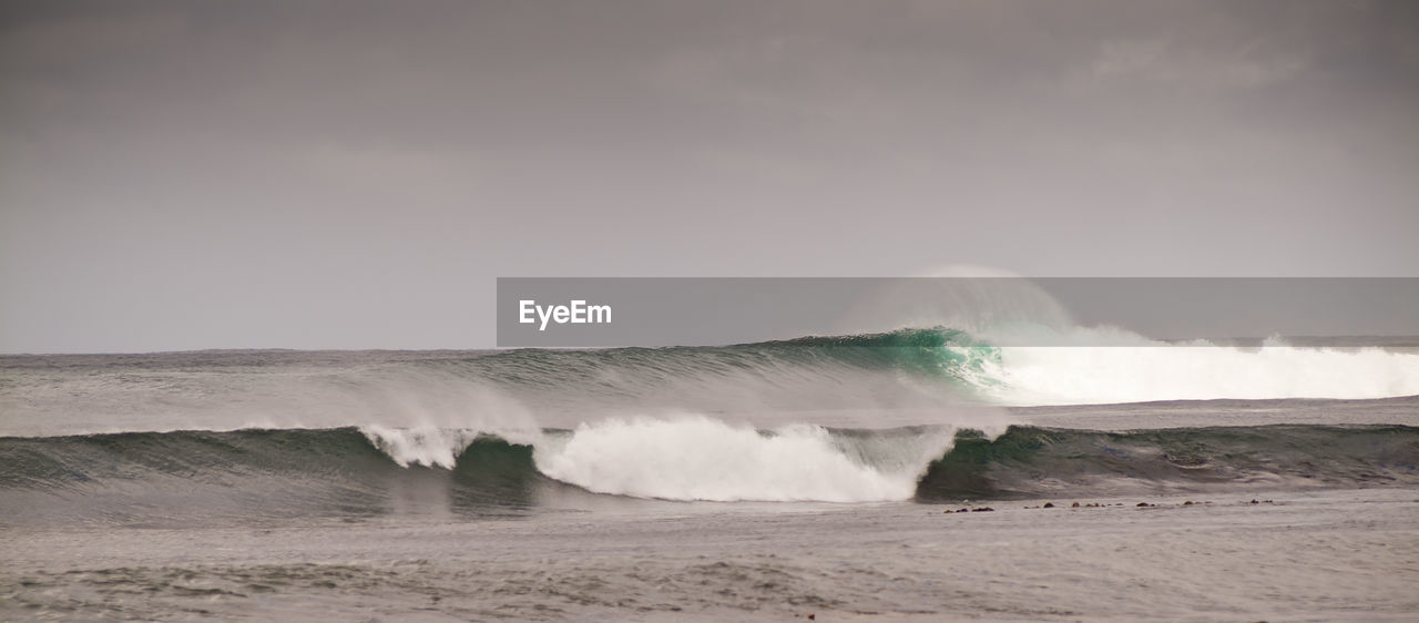 SCENIC VIEW OF WAVES SPLASHING ON SHORE