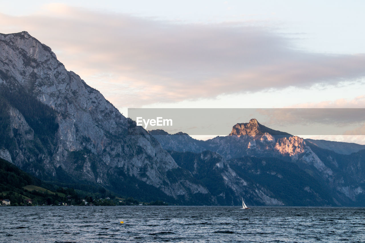 SCENIC VIEW OF SEA AND MOUNTAIN AGAINST SKY