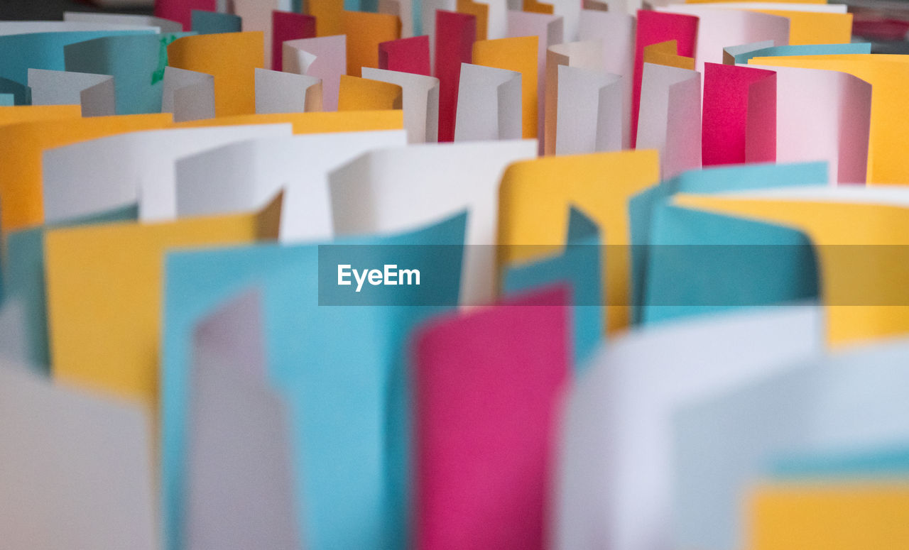 multi colored, large group of objects, in a row, indoors, selective focus, variation, no people, education, yellow, business, close-up, abundance, office, order, blue, toy