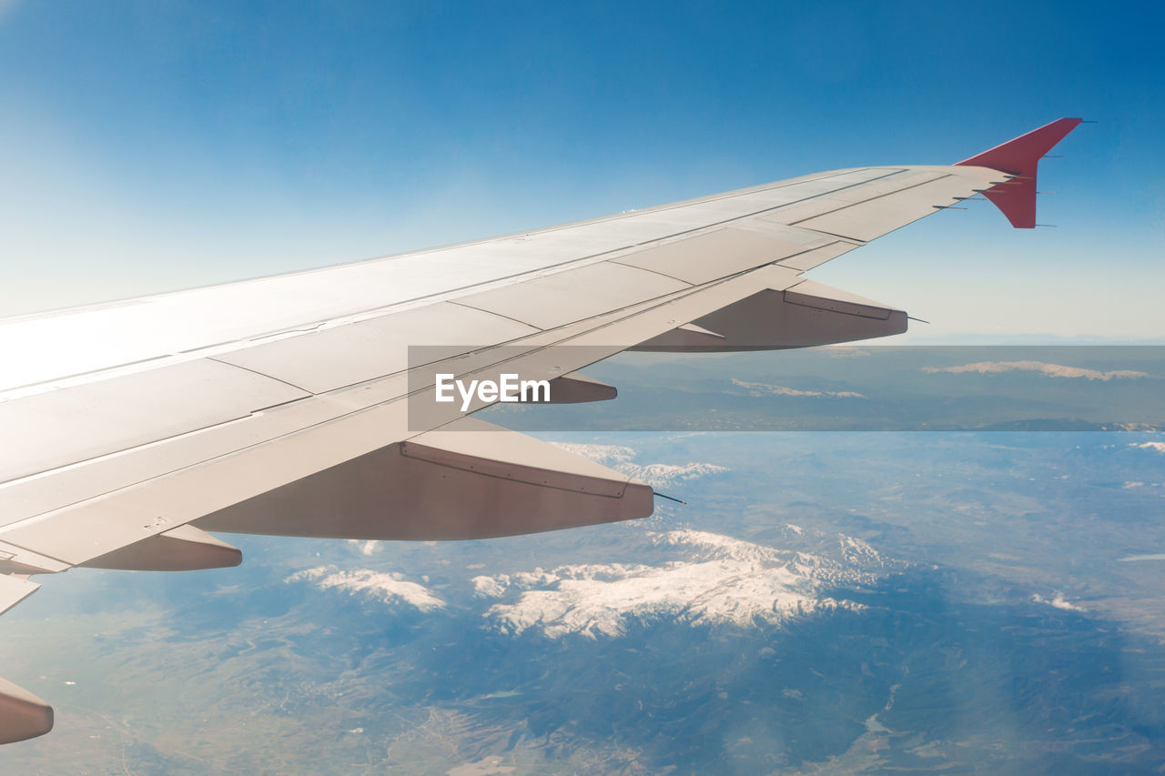 Aerial view of aircraft wing against sky