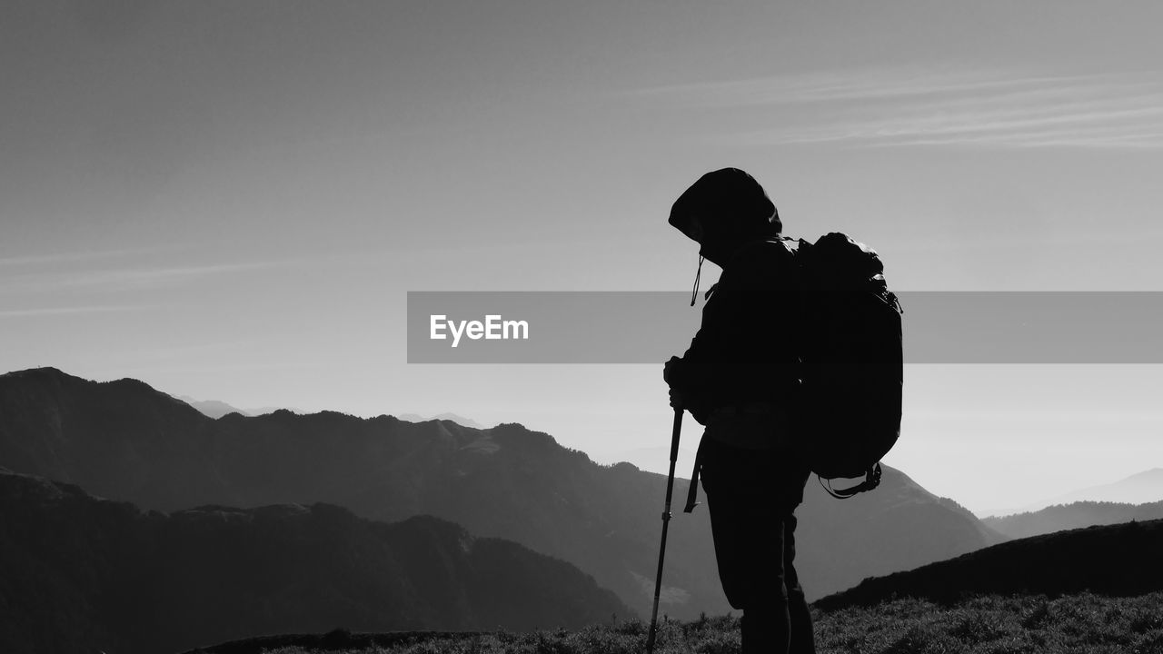 Man standing on mountain against sky