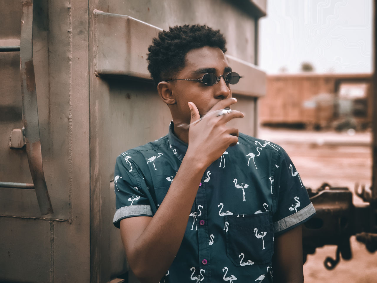 YOUNG MAN LOOKING AWAY WHILE STANDING AGAINST TEXT