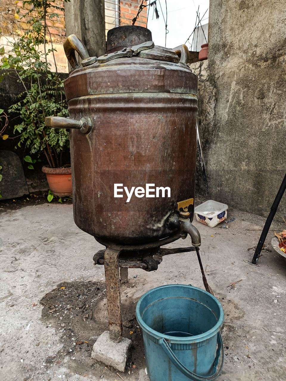 iron, day, container, nature, architecture, no people, metal, building exterior, outdoors, plant, built structure, street, household equipment, potted plant, kitchen utensil, bucket, broom, wall - building feature, front or back yard, barbecue grill