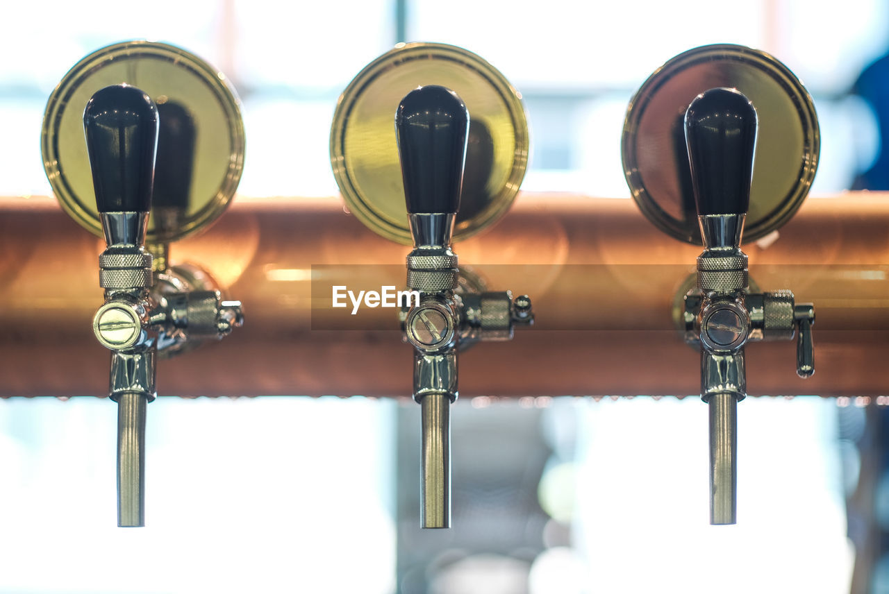 Row of draft beer tab on the top of counter bar in closeup view, time of celebration.