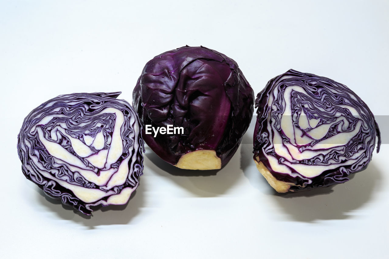 High angle view of purple cabbage over white background