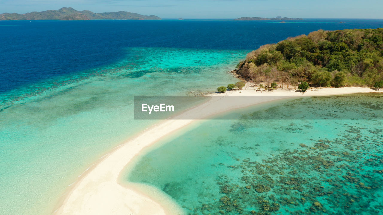 Aerial seascape tropical island with sand bar, turquoise water and coral reef. ditaytayan, 