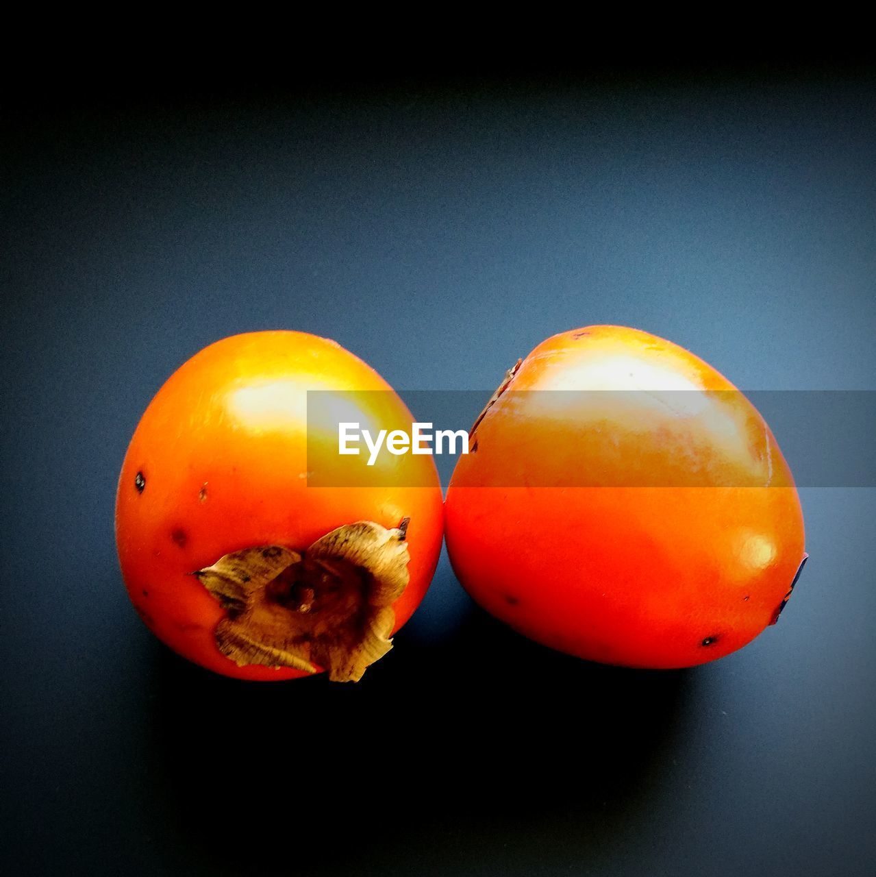 Close-up of persimmon on table