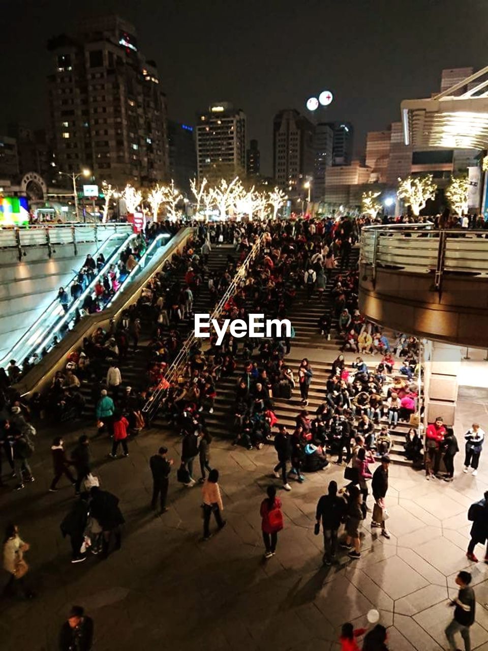 HIGH ANGLE VIEW OF PEOPLE WALKING ON ILLUMINATED STREET