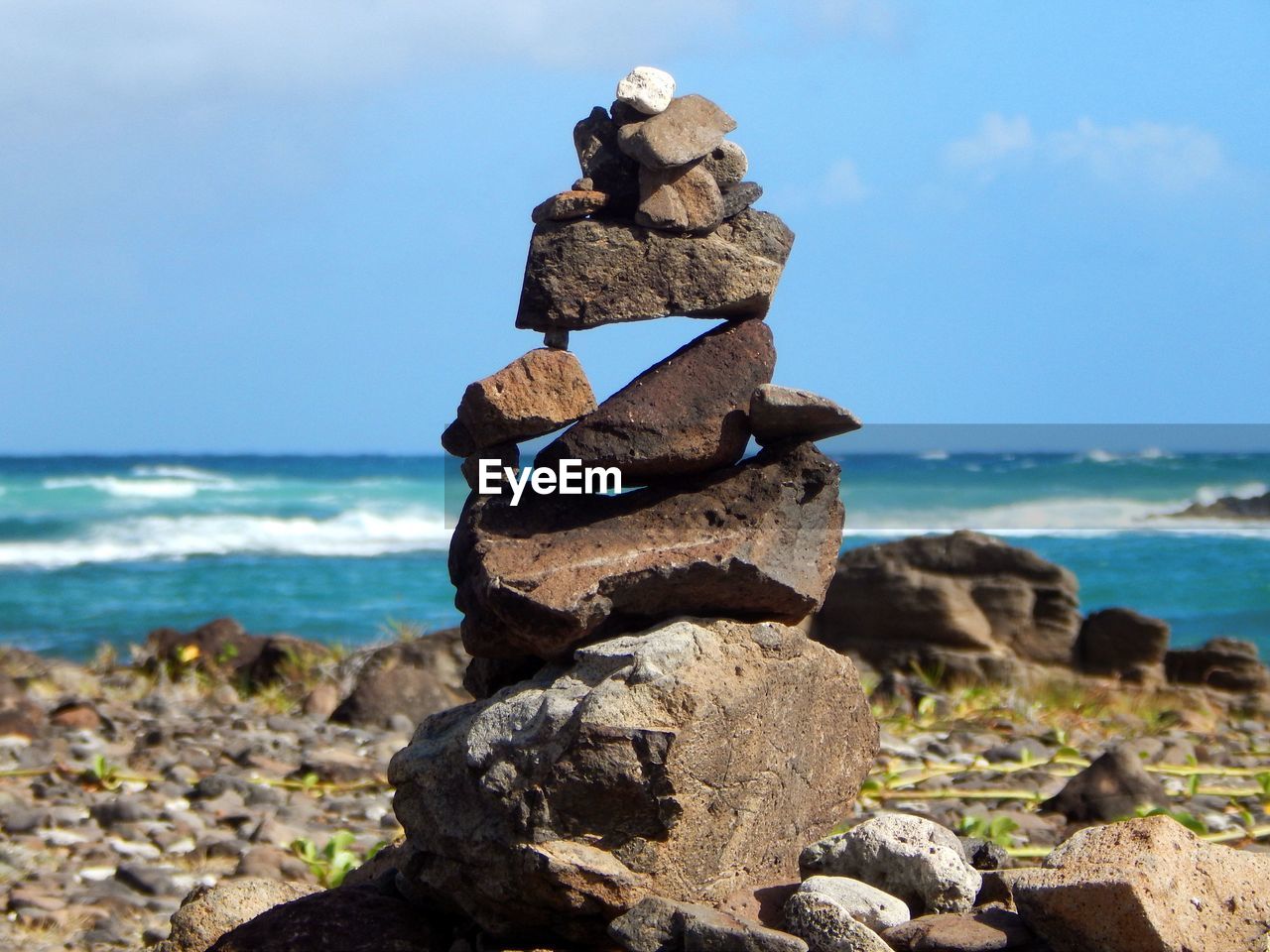 STACK OF ROCKS ON SHORE AGAINST SKY