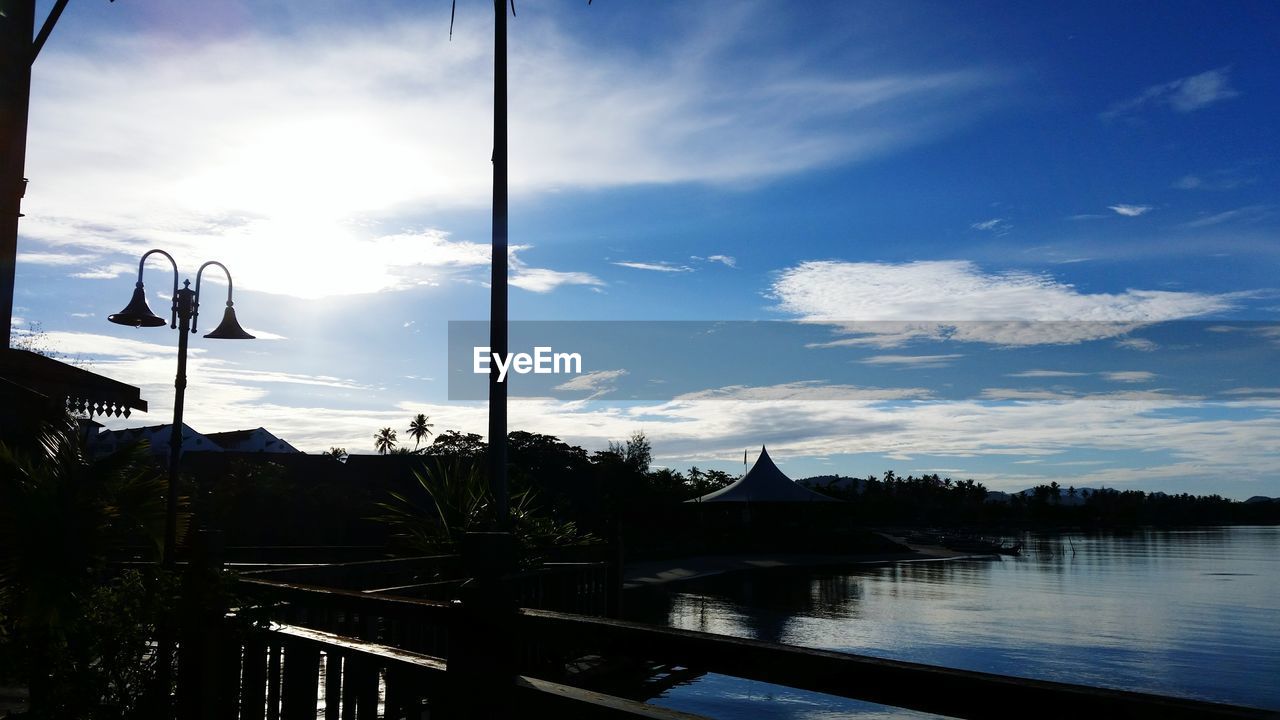 SAILBOATS ON RIVER AGAINST SKY