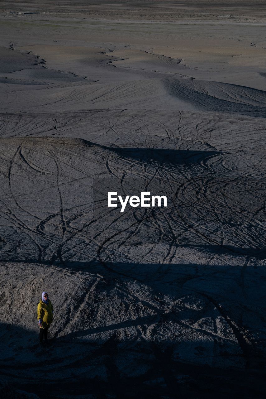 High angle view of woman standing at beach during winter