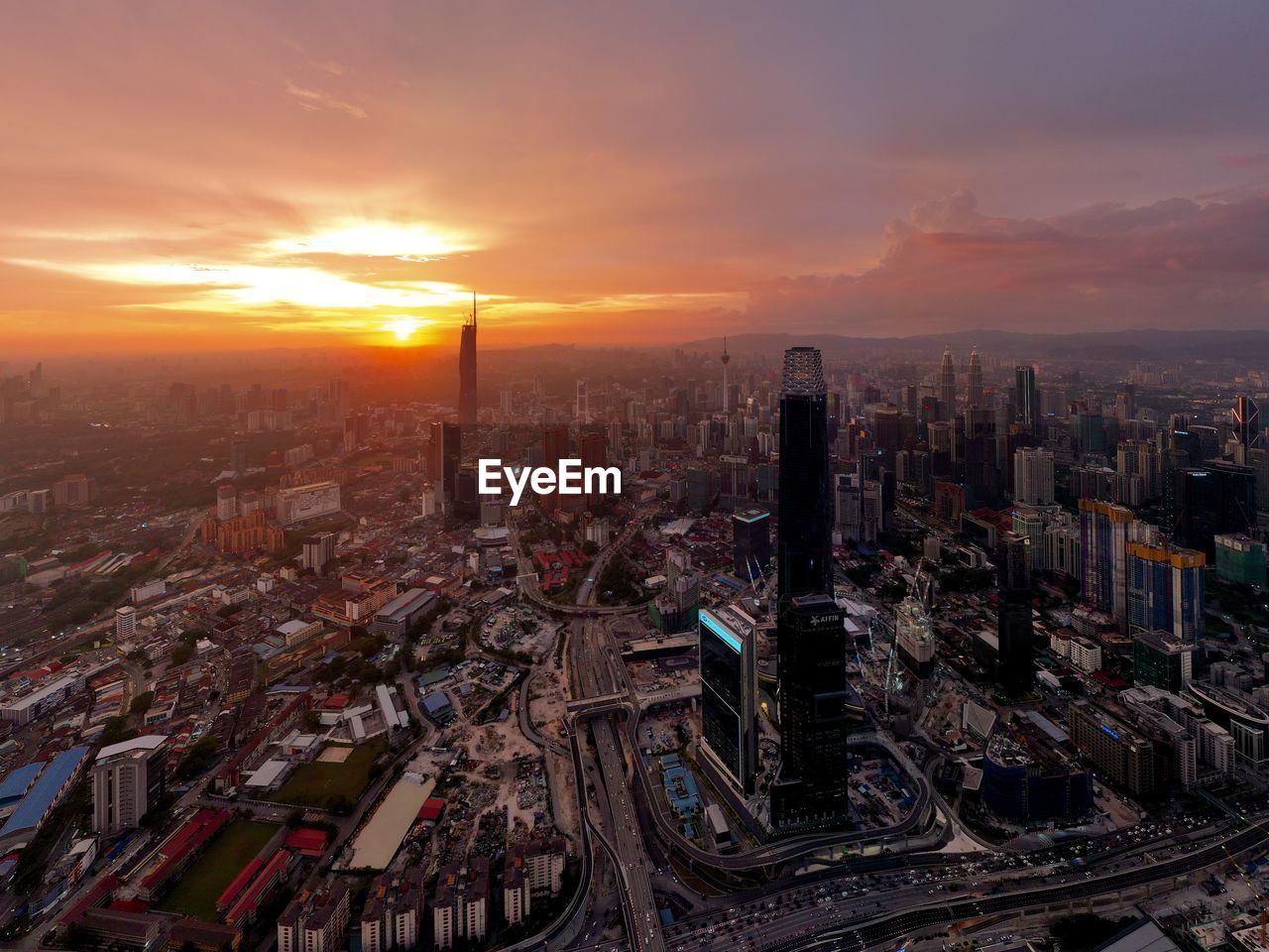 High angle view of city at sunset