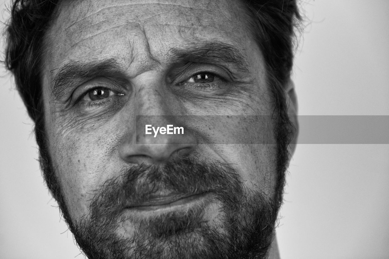 Portrait of mid-adult man on white background