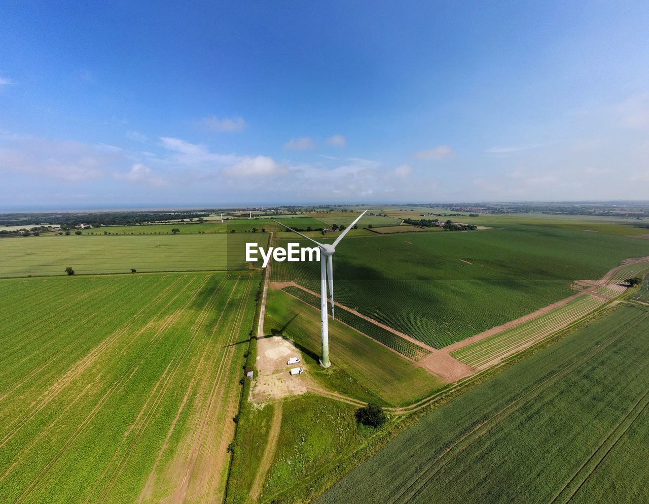 Aerial drone photo of a wind turbine close up in green field