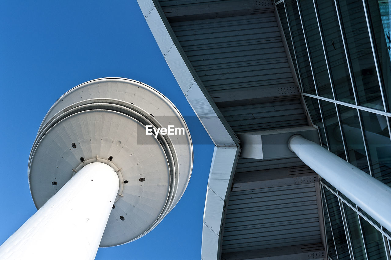 Low angle view of heinrich-hertz-turm against clear blue sky