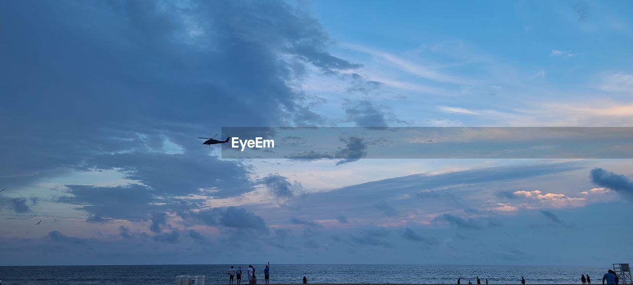 AIRPLANE IN SEA AGAINST SKY