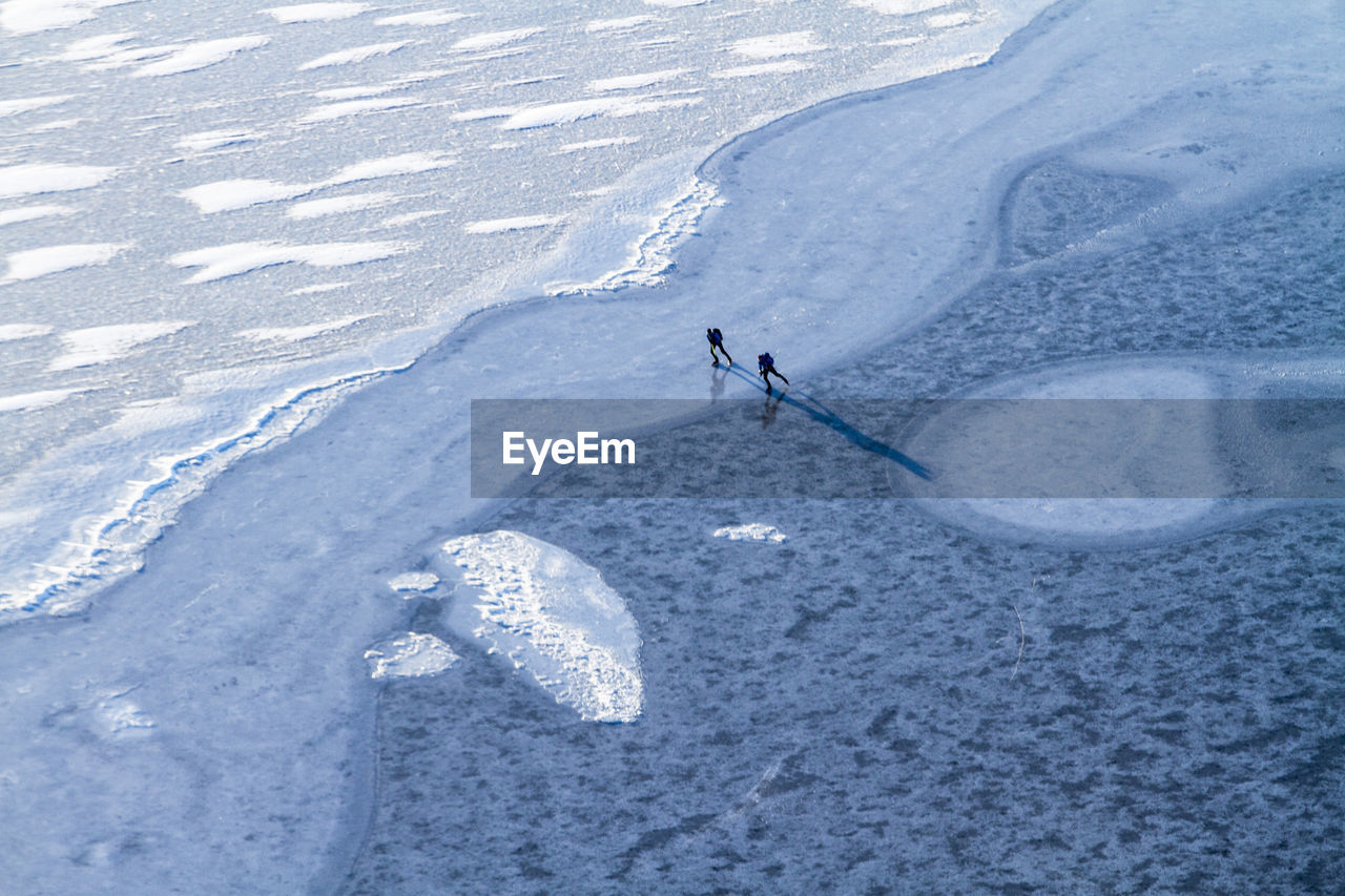 People ice-skating on frozen water