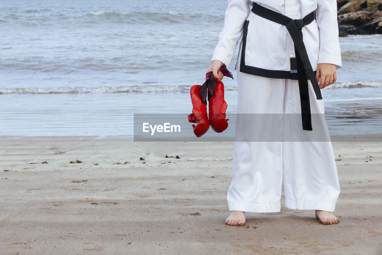 Rear view of woman standing on beach