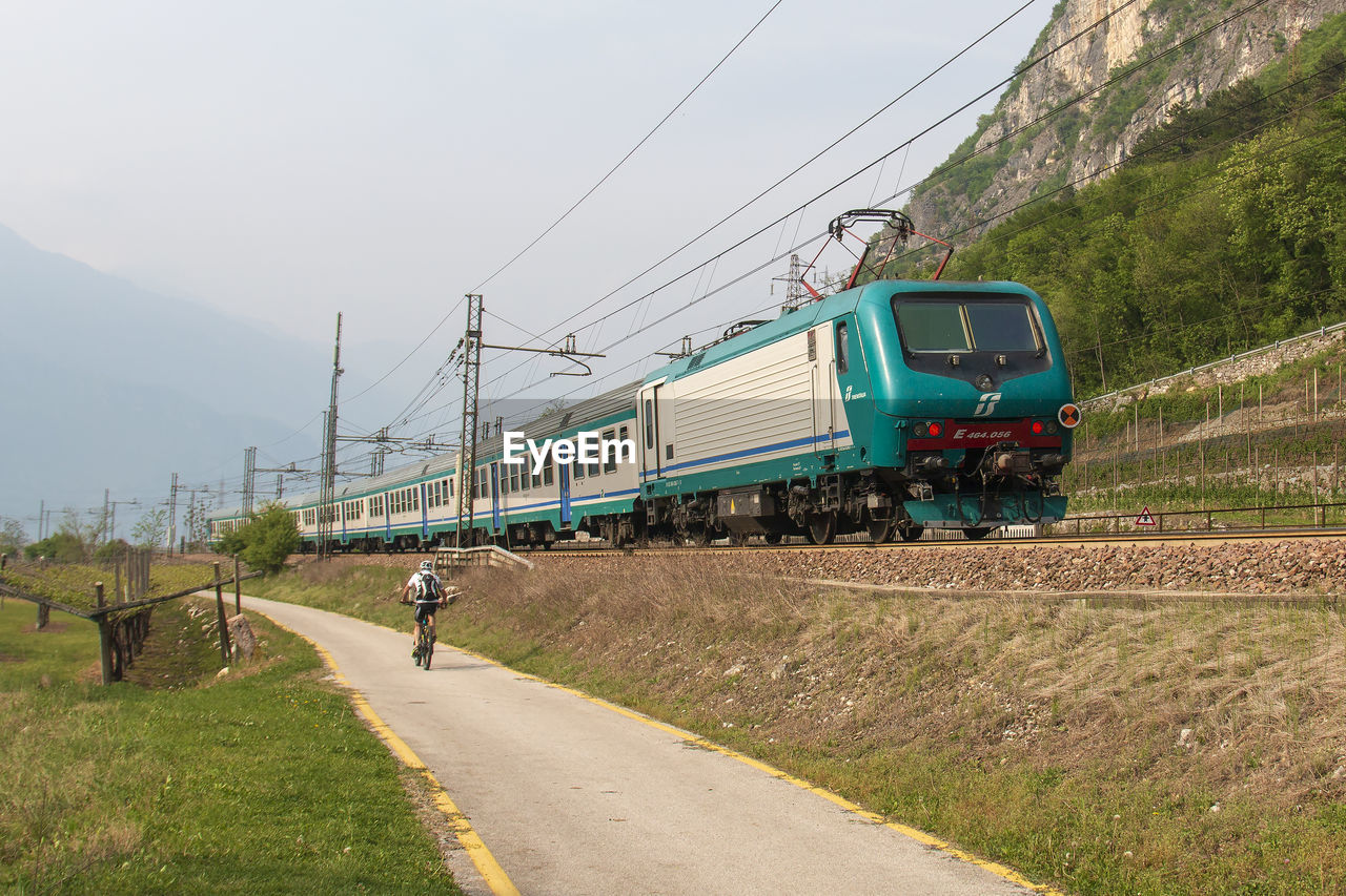 TRAIN BY ROAD AGAINST SKY