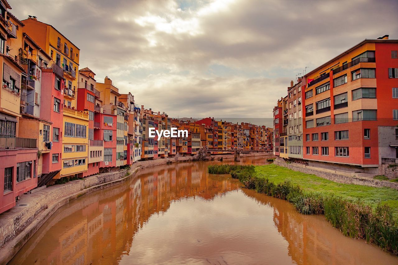 River amidst buildings against sky