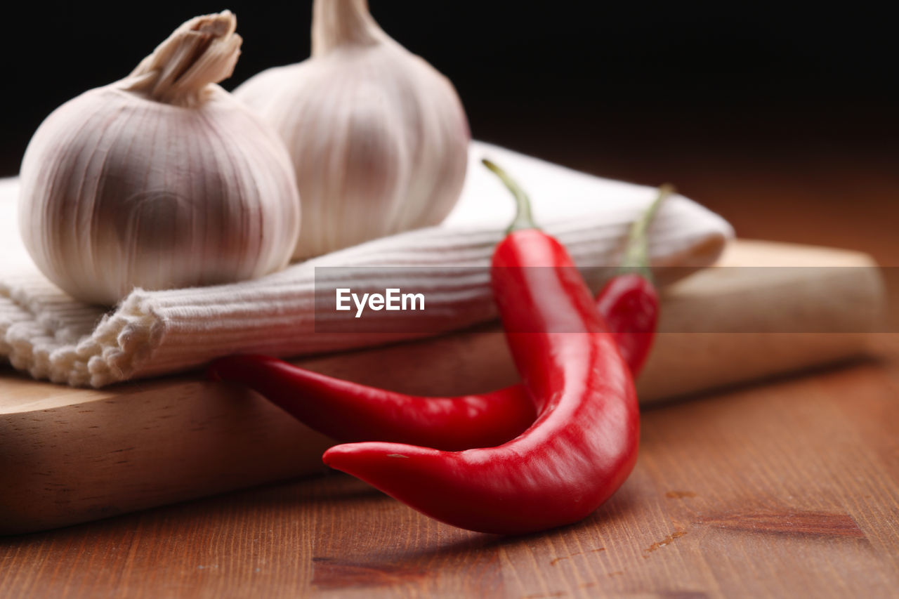 Close-up of red chili peppers and garlic on table