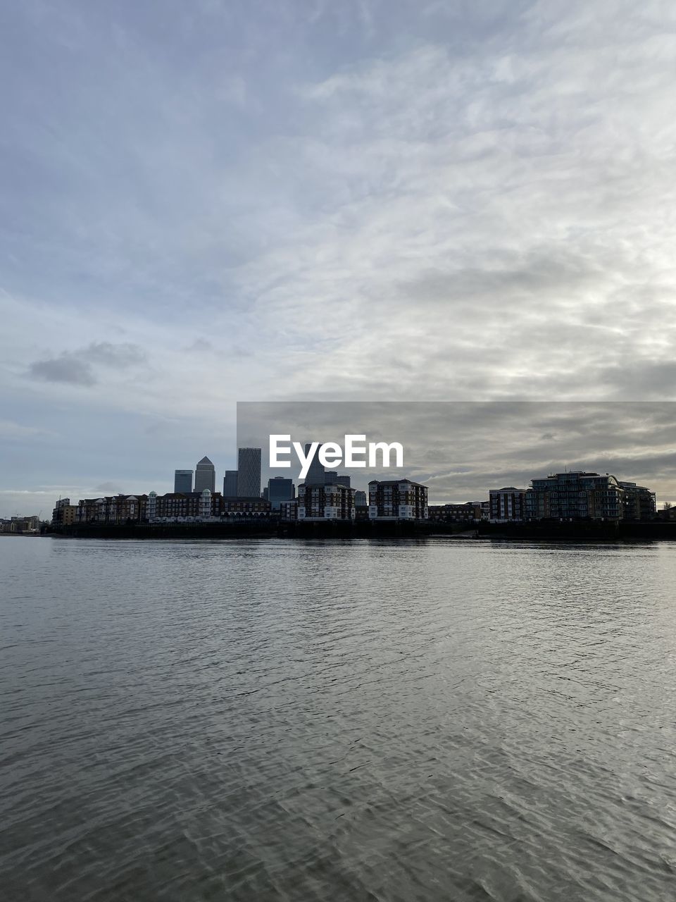 SEA AND BUILDINGS AGAINST SKY