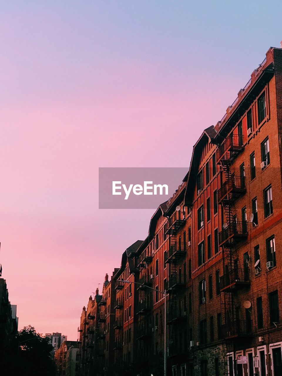 RESIDENTIAL BUILDINGS AGAINST SKY DURING SUNSET