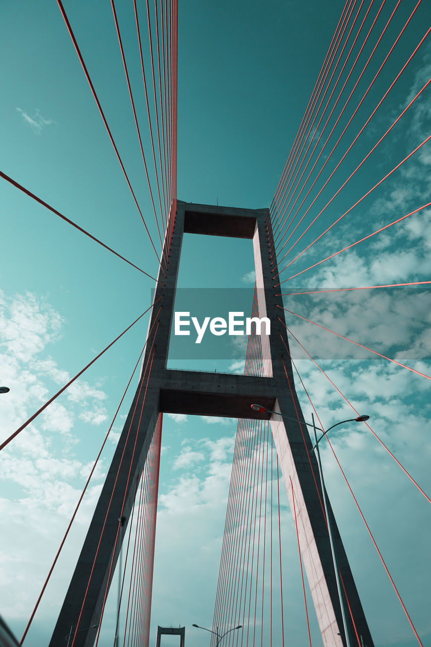 LOW ANGLE VIEW OF SUSPENSION BRIDGE CABLES AGAINST SKY