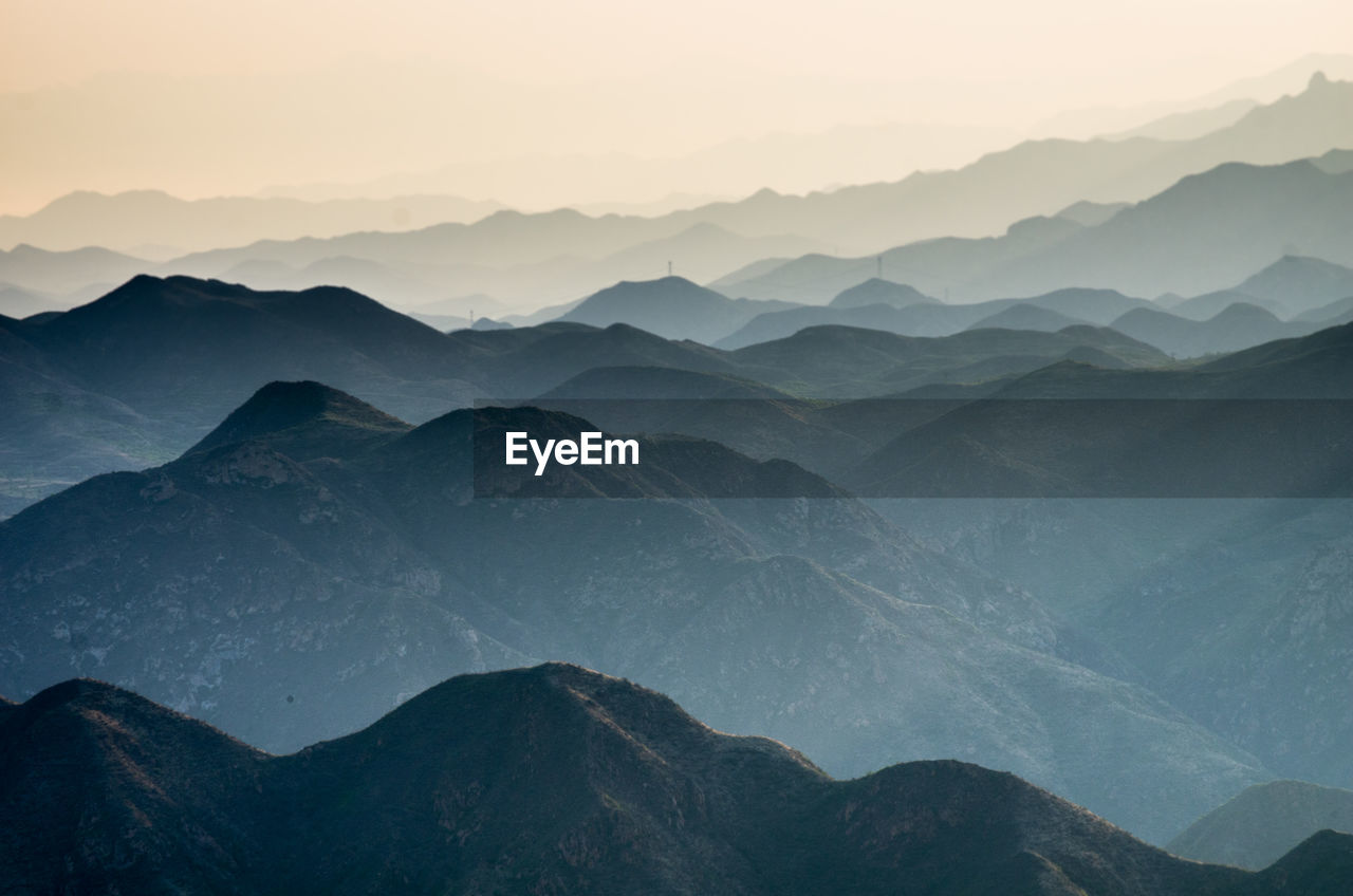 Aerial view of silhouette mountains against clear sky