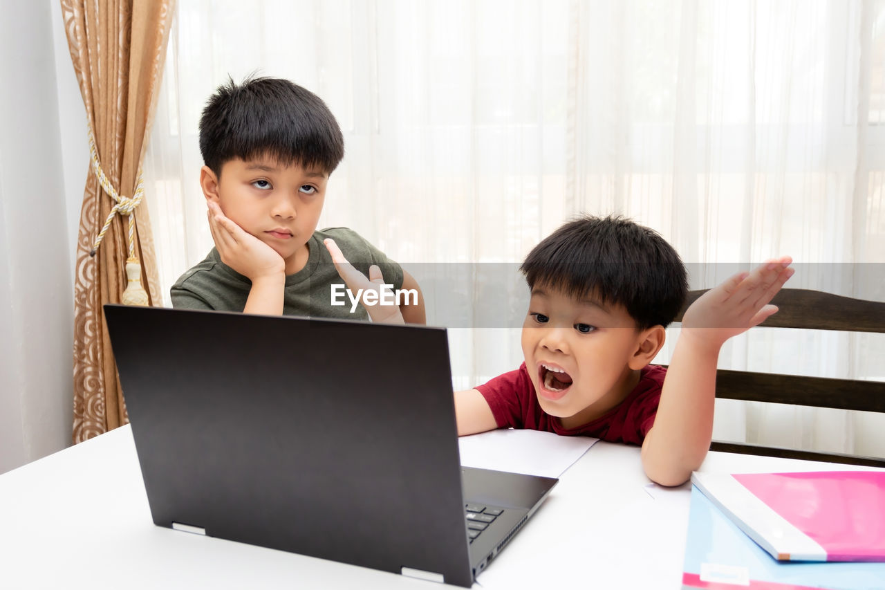 Asian students studying math, homework during online lessons at home. 
