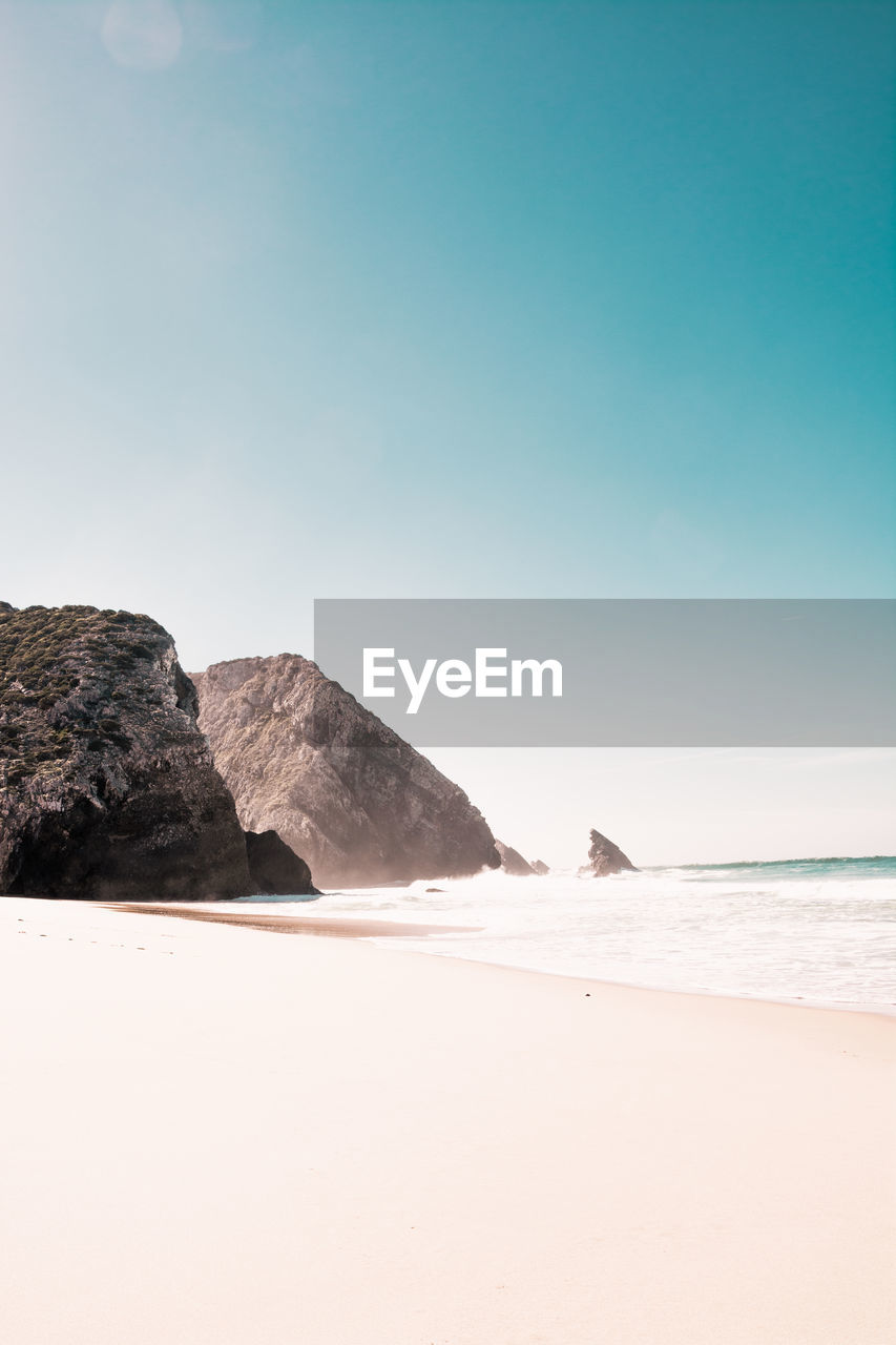 Scenic view of beach against clear sky