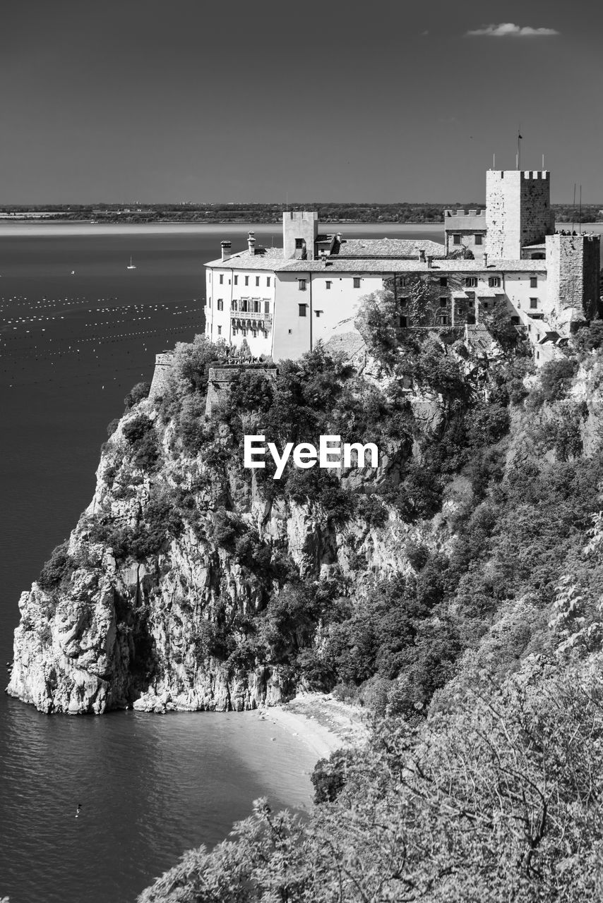 High angle view of buildings by sea against sky