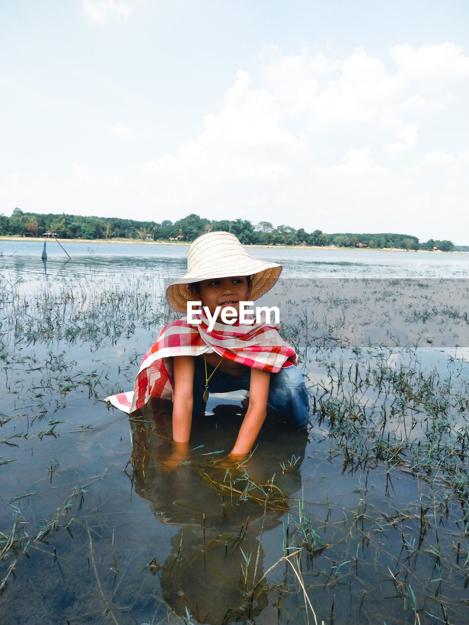 Girl working in agricultural field against sky