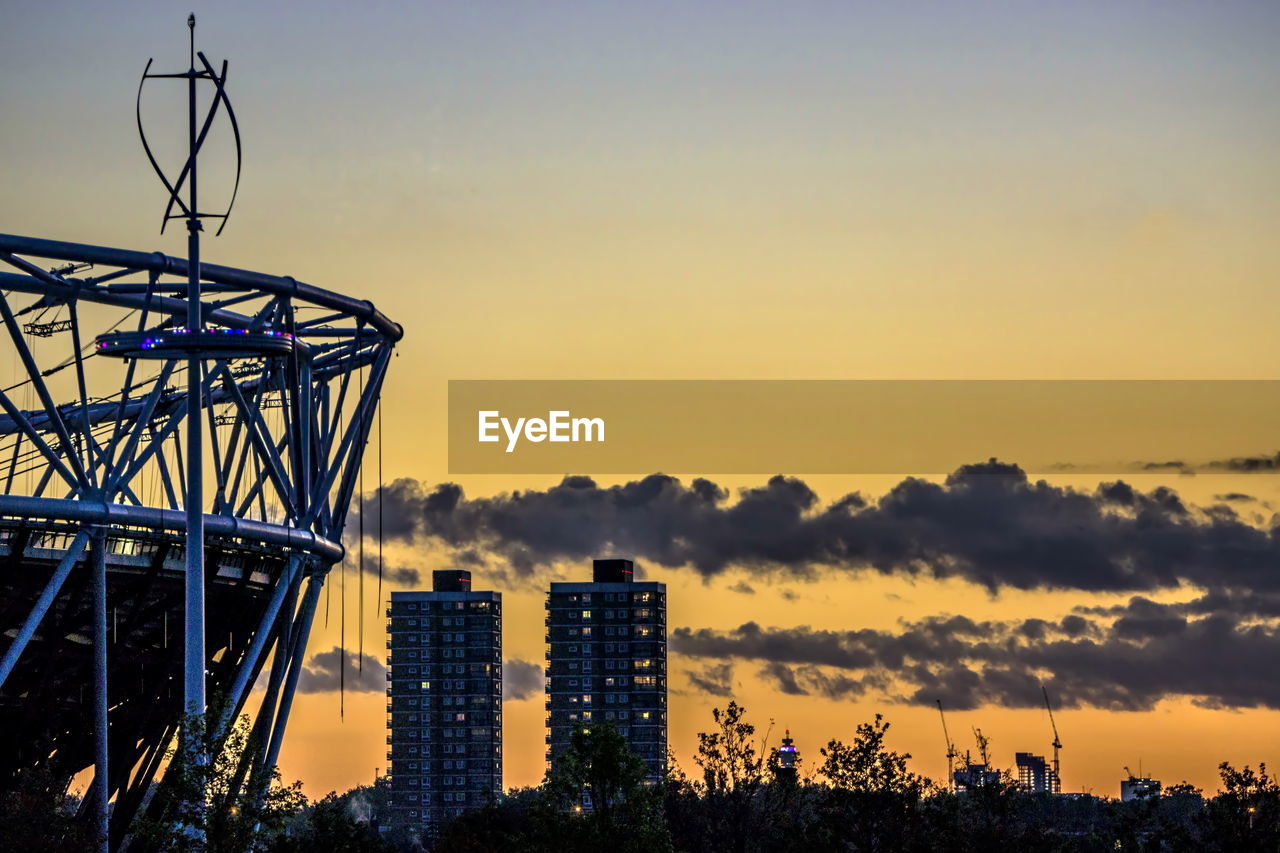 LOW ANGLE VIEW OF SILHOUETTE FERRIS WHEEL DURING SUNSET