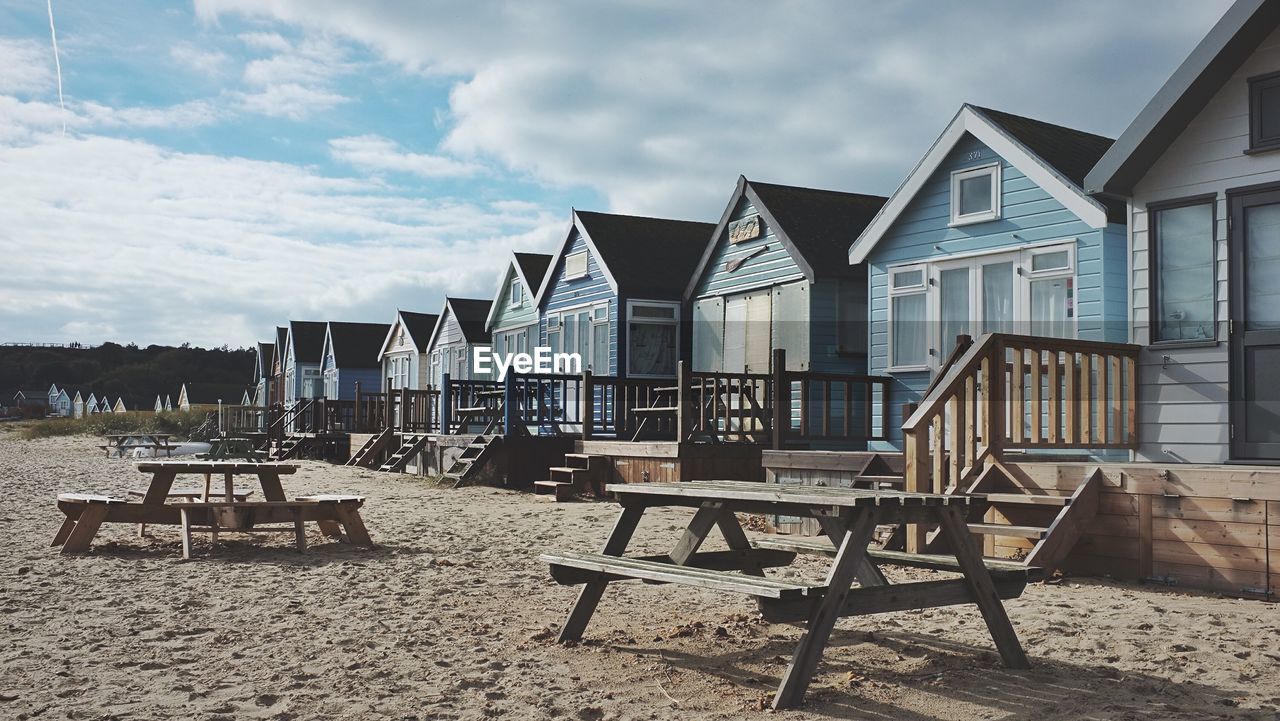 Chairs on beach against sky