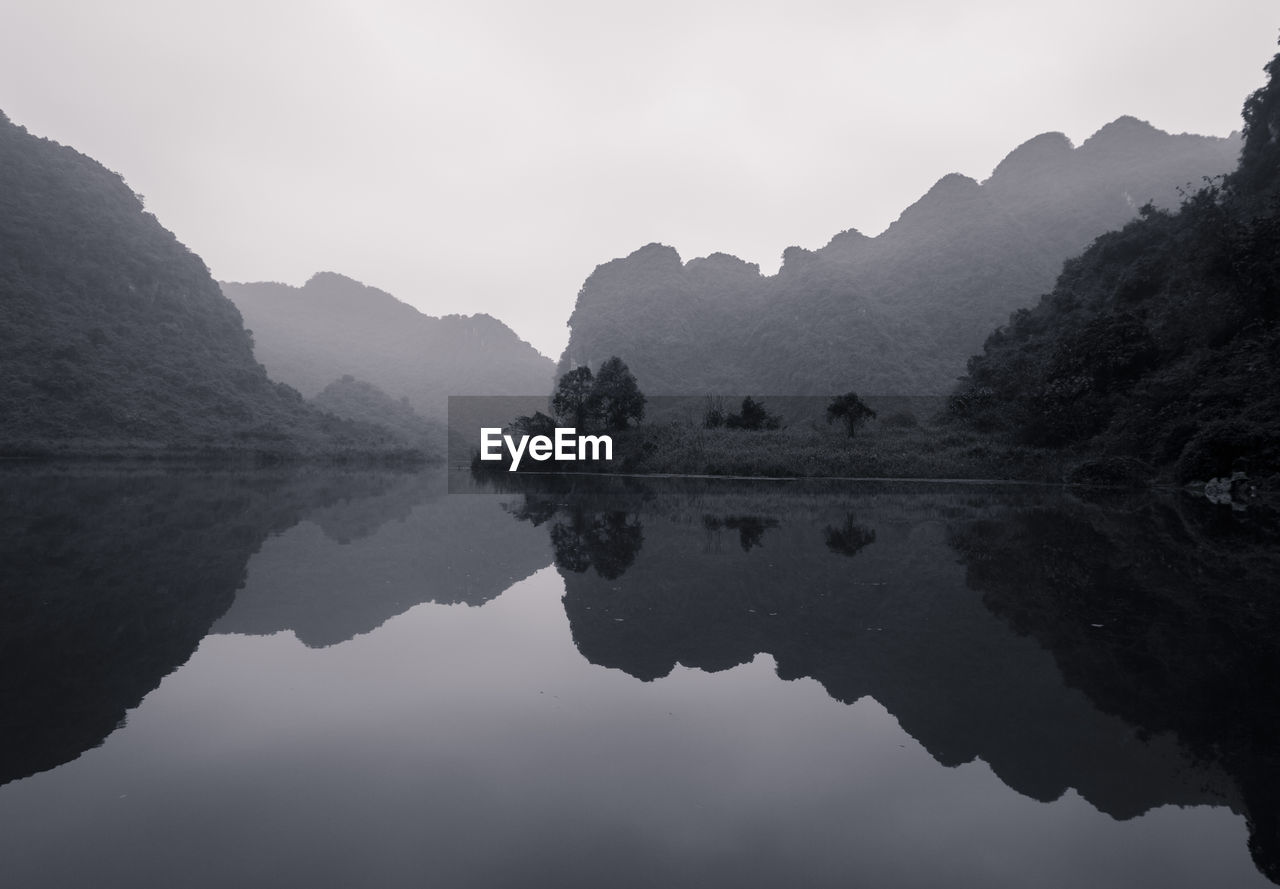 Scenic view of lake and mountains against sky