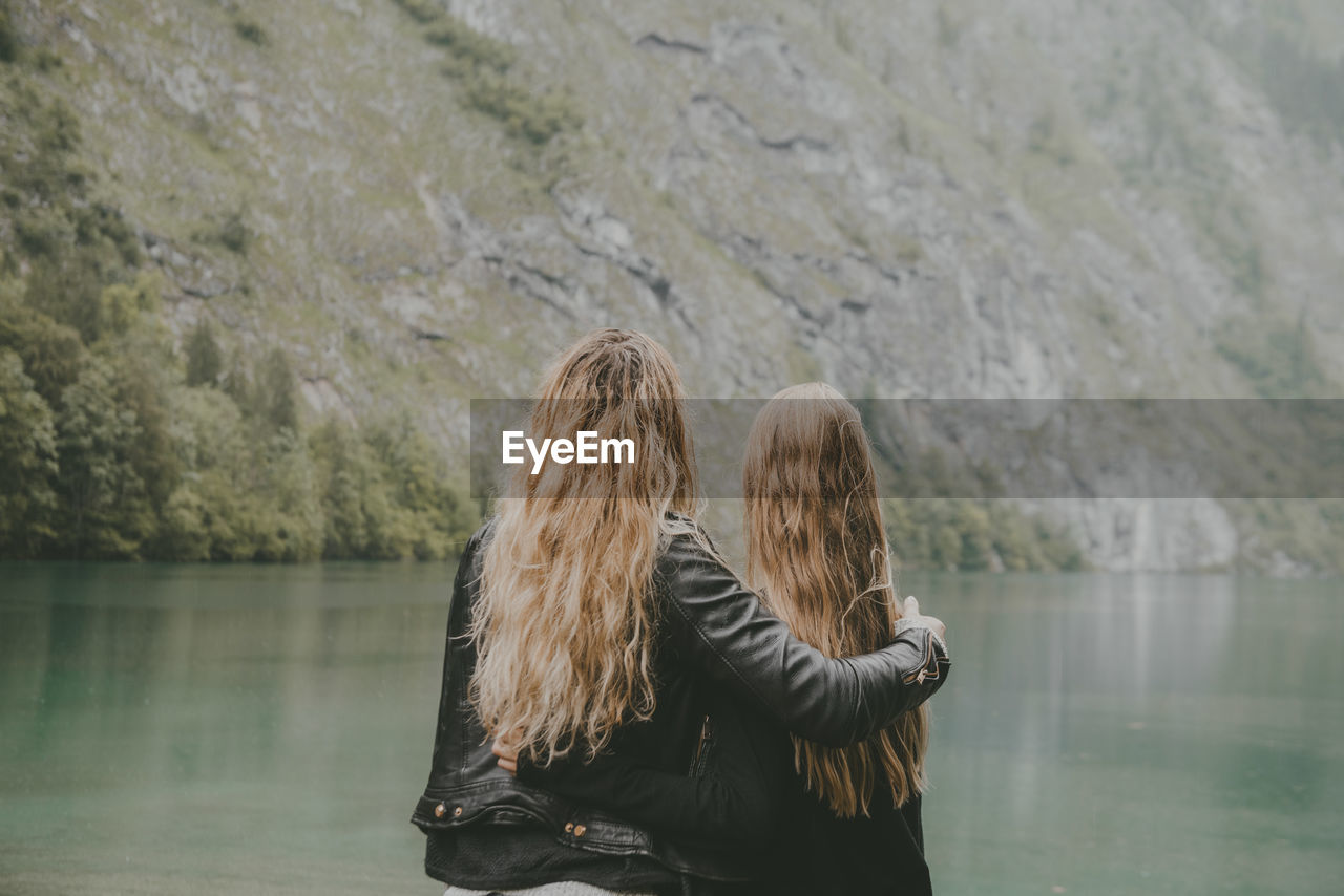 Rear view of two female friends looking at view